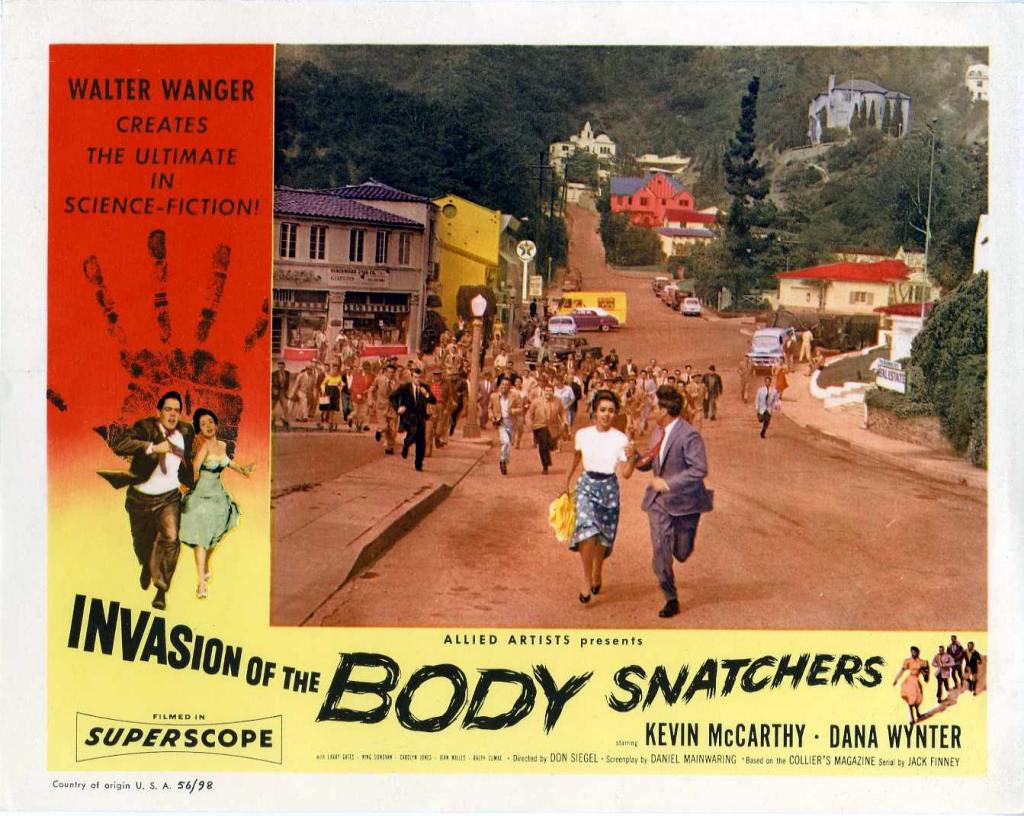 Protagonists run from an angry mob. Side text: Walter Wagner creates the ultimate in science-fiction! Allied artists presents Invasion of the Body Snatchers starring Kevin McCarthy and Dana Wynter. Filmed in Superscope.