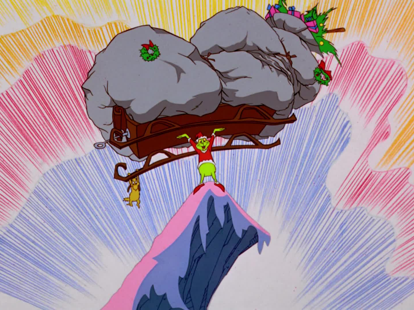 A still from "How The Grinch Stole Christmas!" featuring the grinch dressed as Santa holding up a heavily-laden sleigh at the top of a cliff