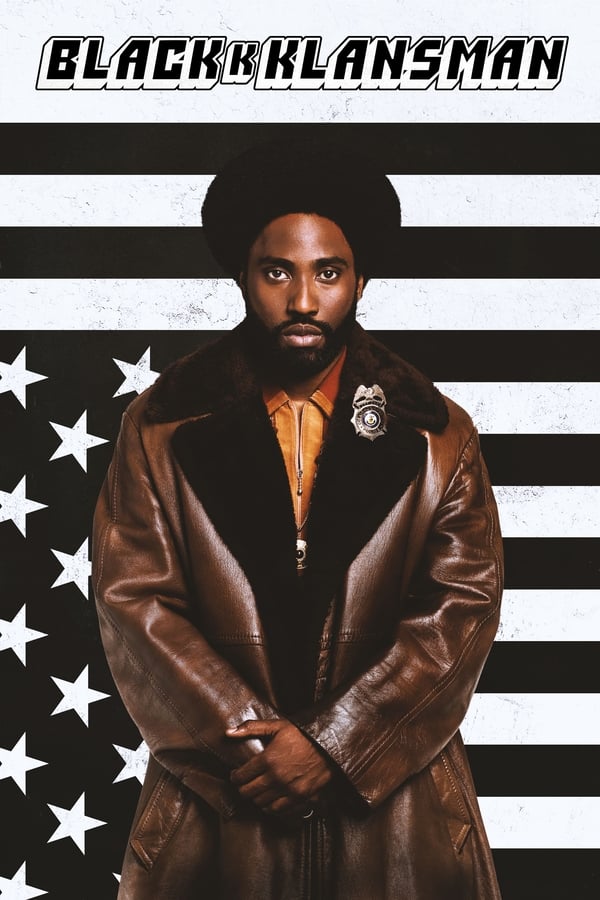 Poster for "BlacKkKlansman" featuring a man posing in front of black and white stars and stripes