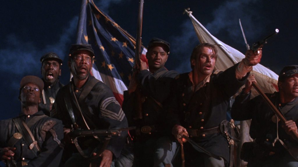 Still from "Glory" featuring a Union army regiment holding flags and guns during a night battle