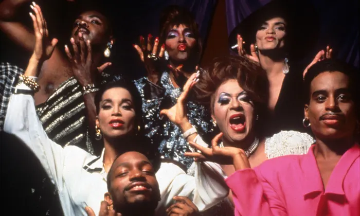Still from "Paris is Burning" featuring a group of drag performers posing for the camera