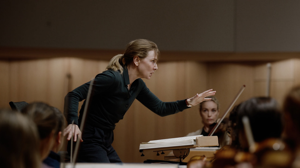 Still from "Tár" featuring a female maestro conducting an orchestra