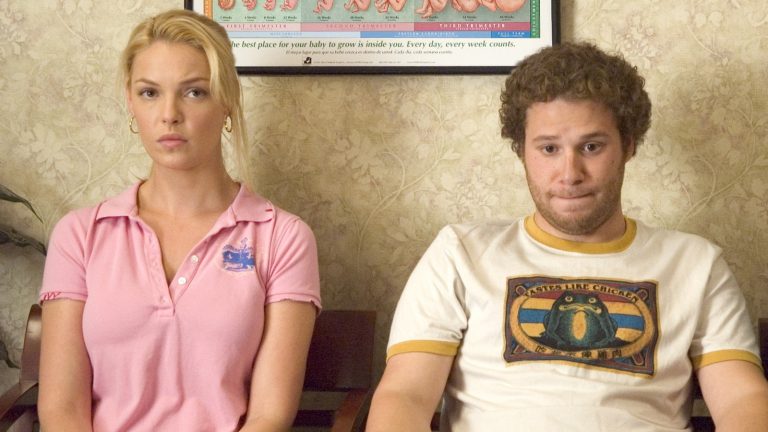 Still from "Knocked Up" featuring a couple sitting awkwardly in an OBGYN office