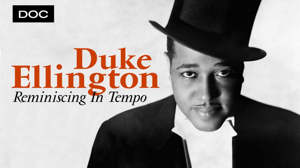 Black and white photo of Duke Ellington in a tuxedo and top hat looking into the camera