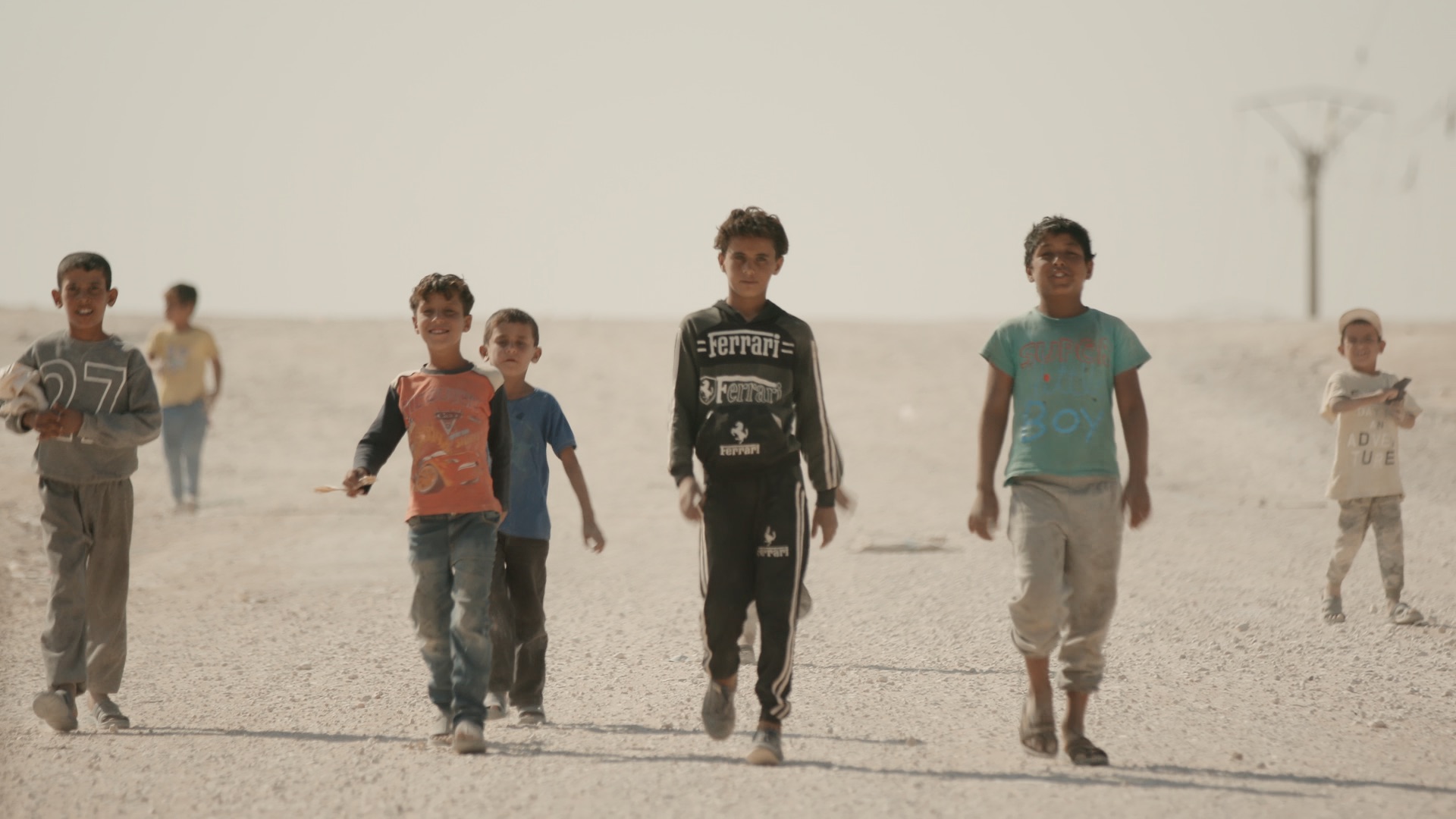 A group of young Iraqi boys walking toward the camera