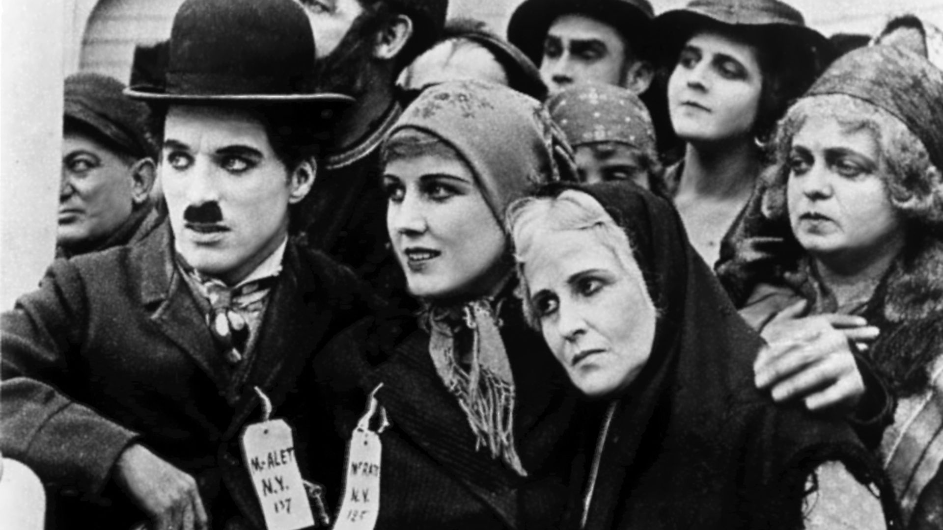 A group of people stand huddled together, facing the camera.