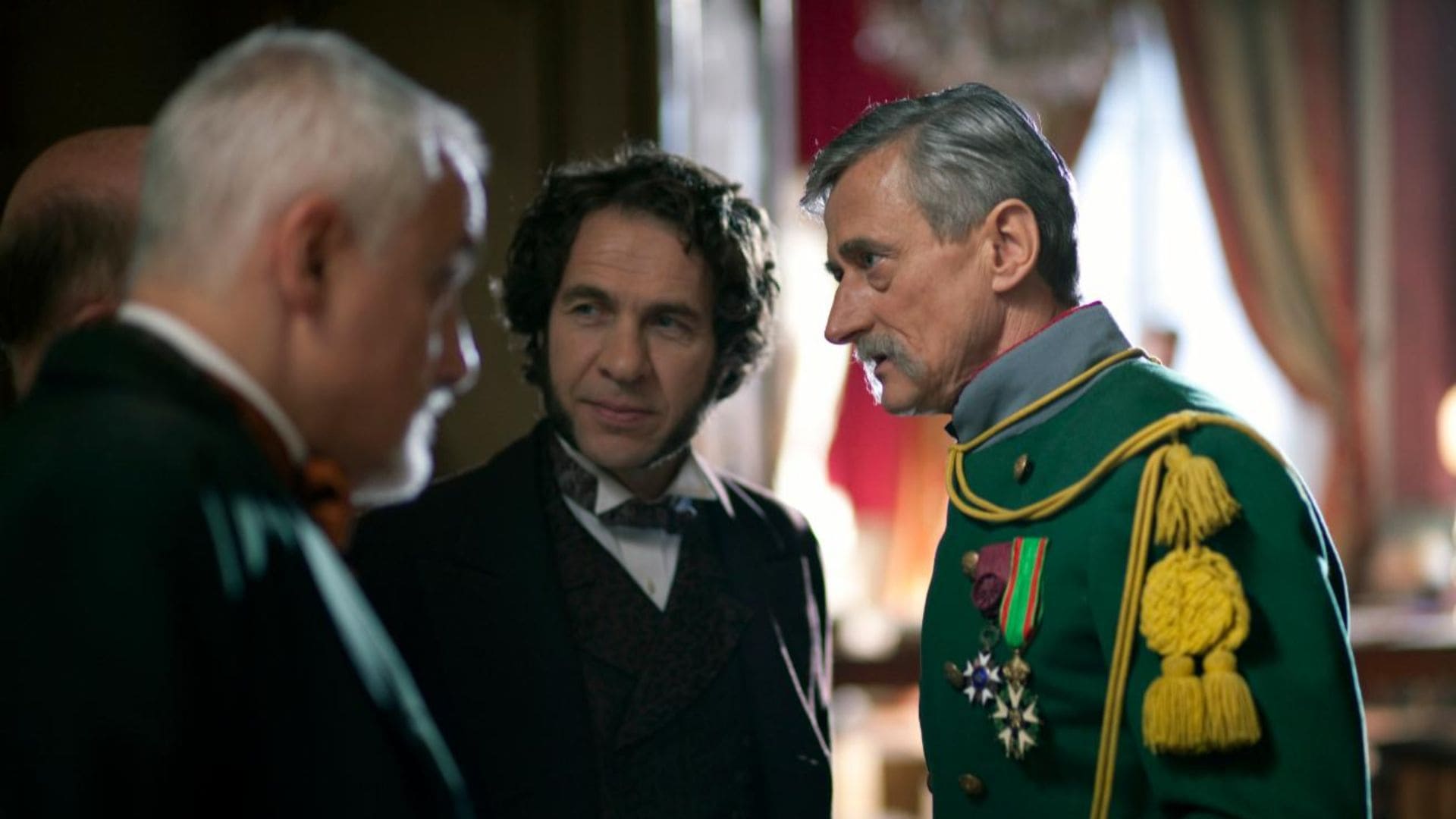 A group of political officials stand in conversation with one another.