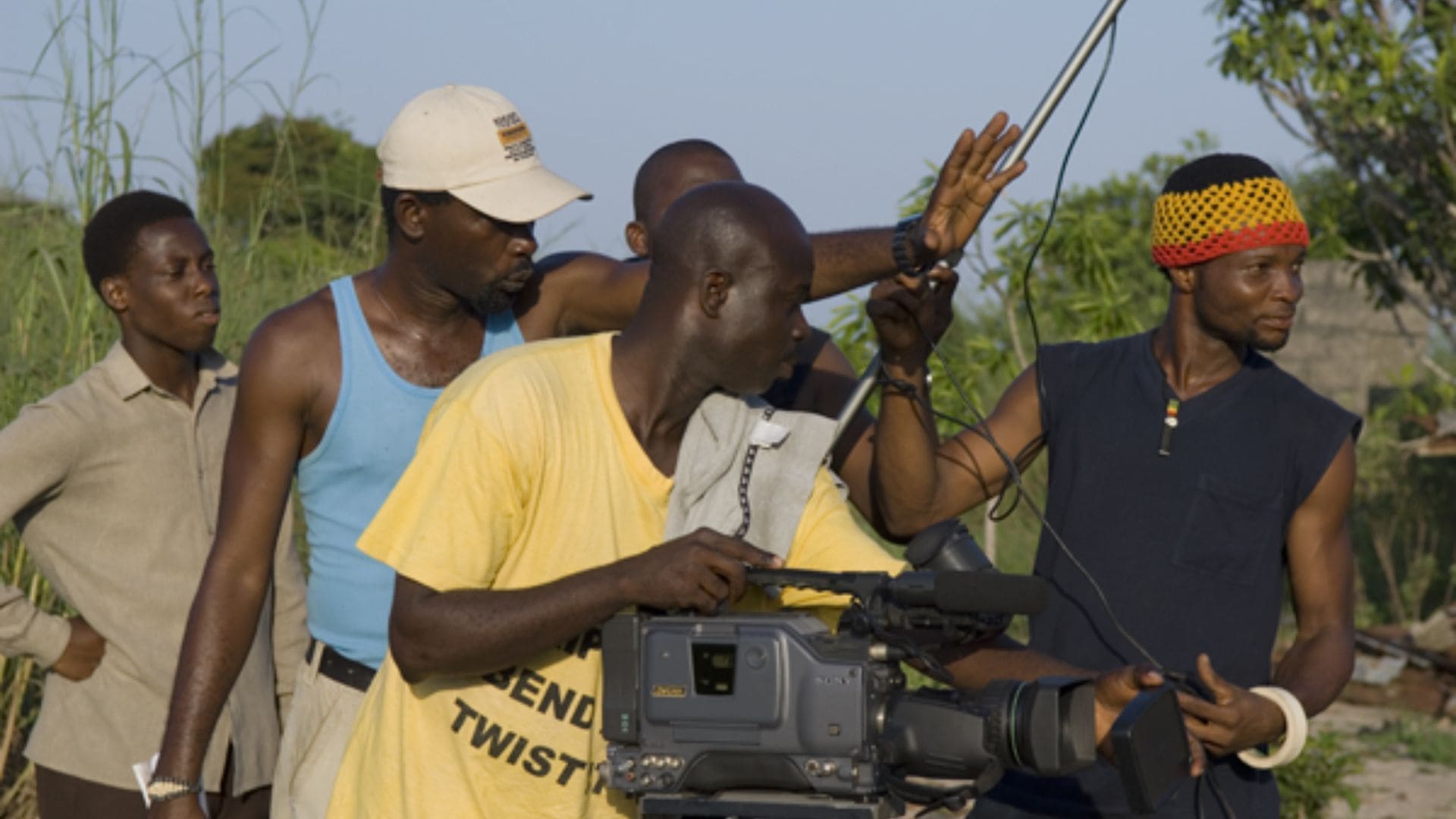 A film crew holds a microphone and camera.