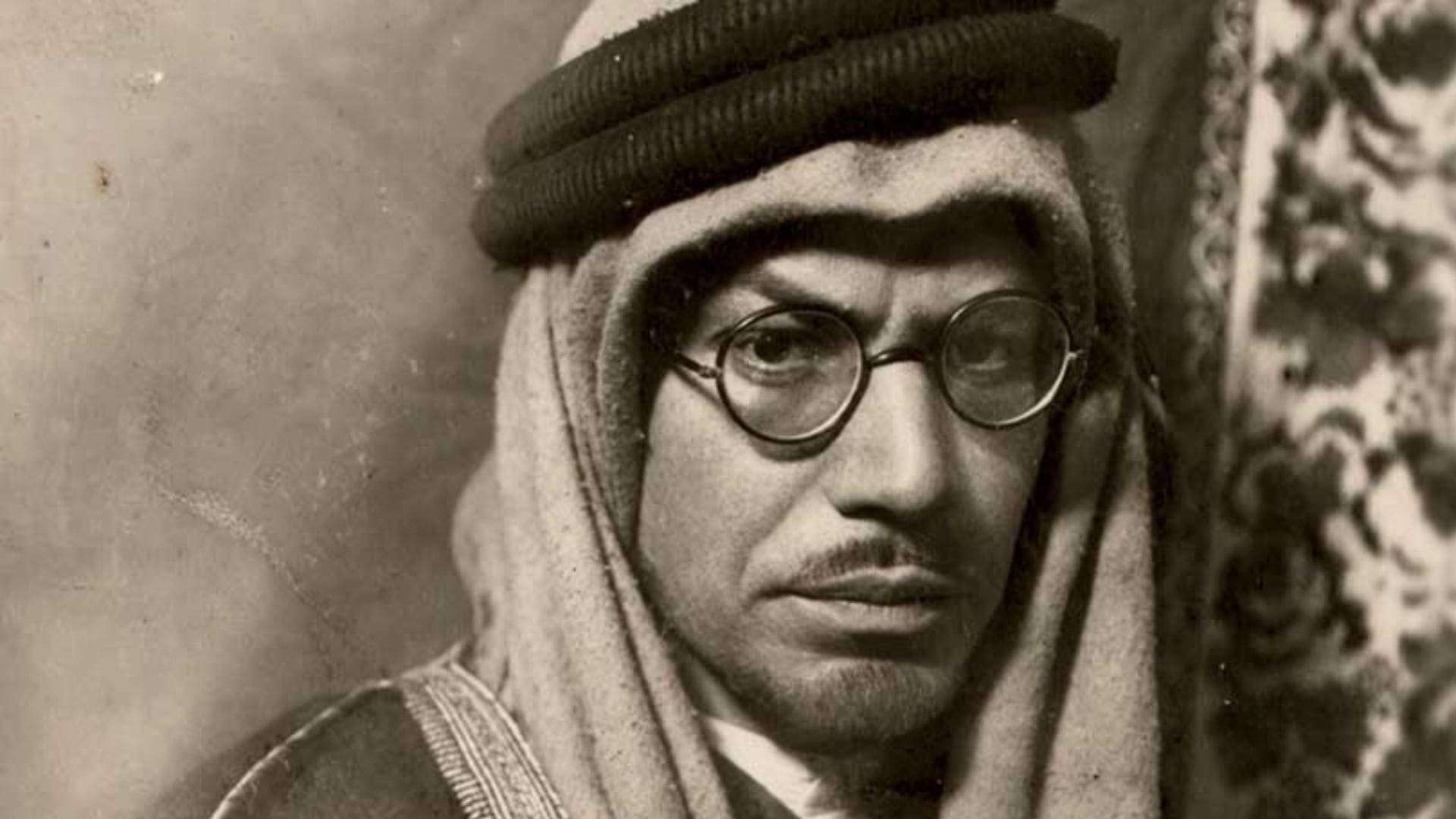 A portrait of Muhammad Asad, dressed in a head covering and glasses.
