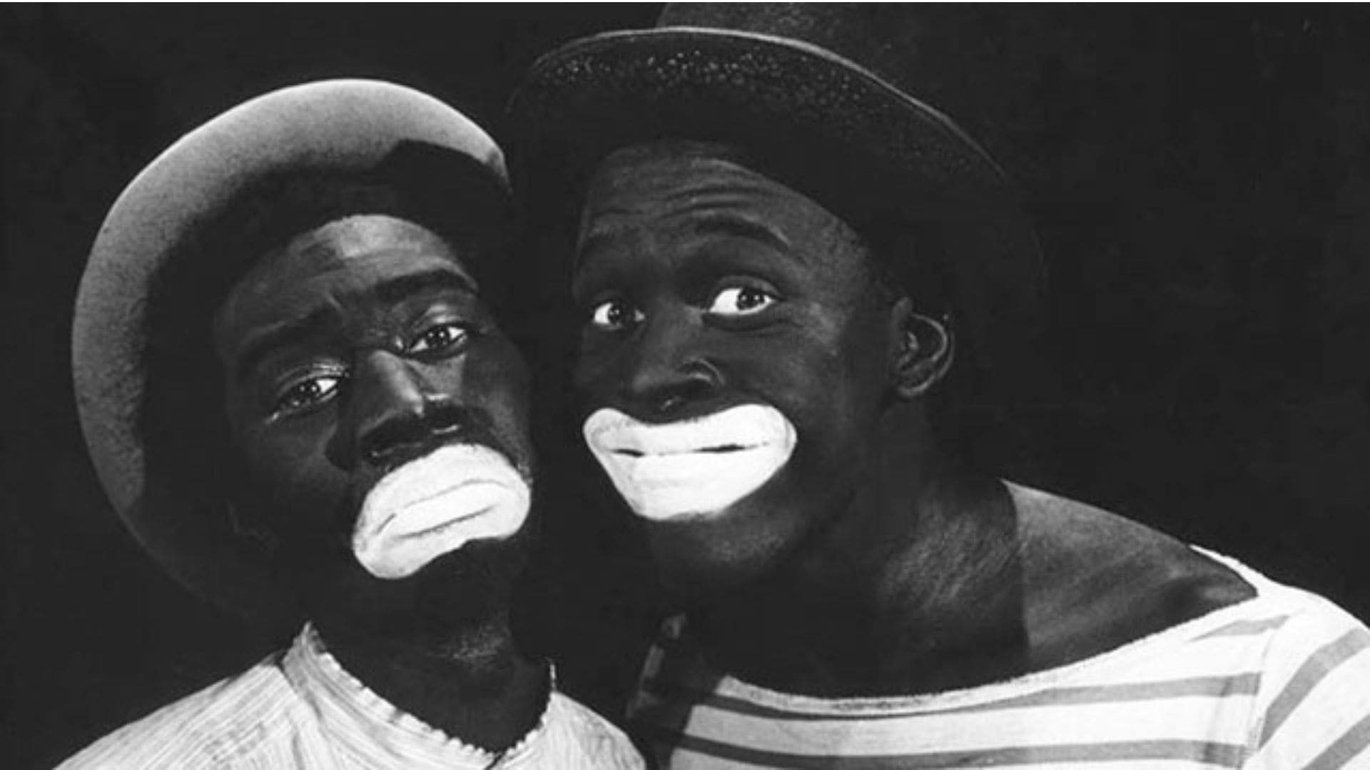 Two white men in blackface pose next to each other.