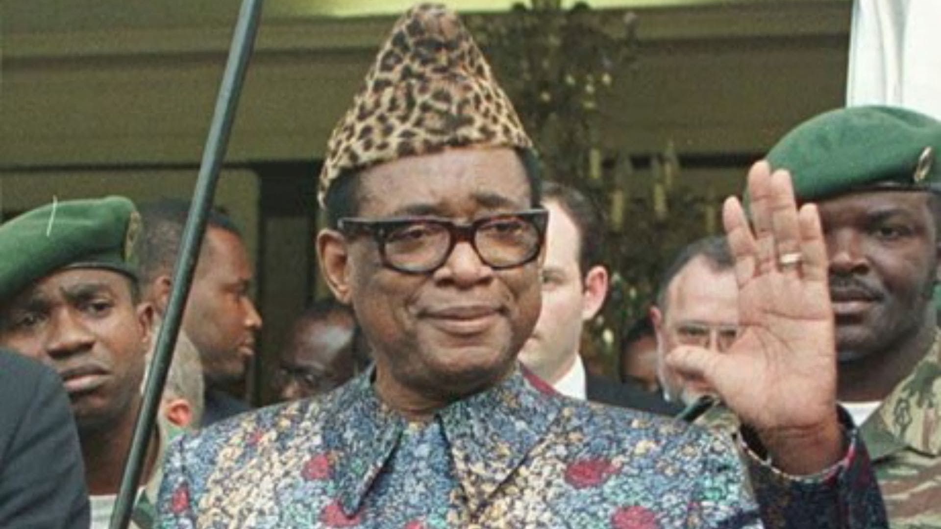 A with a leopard print hat waves.