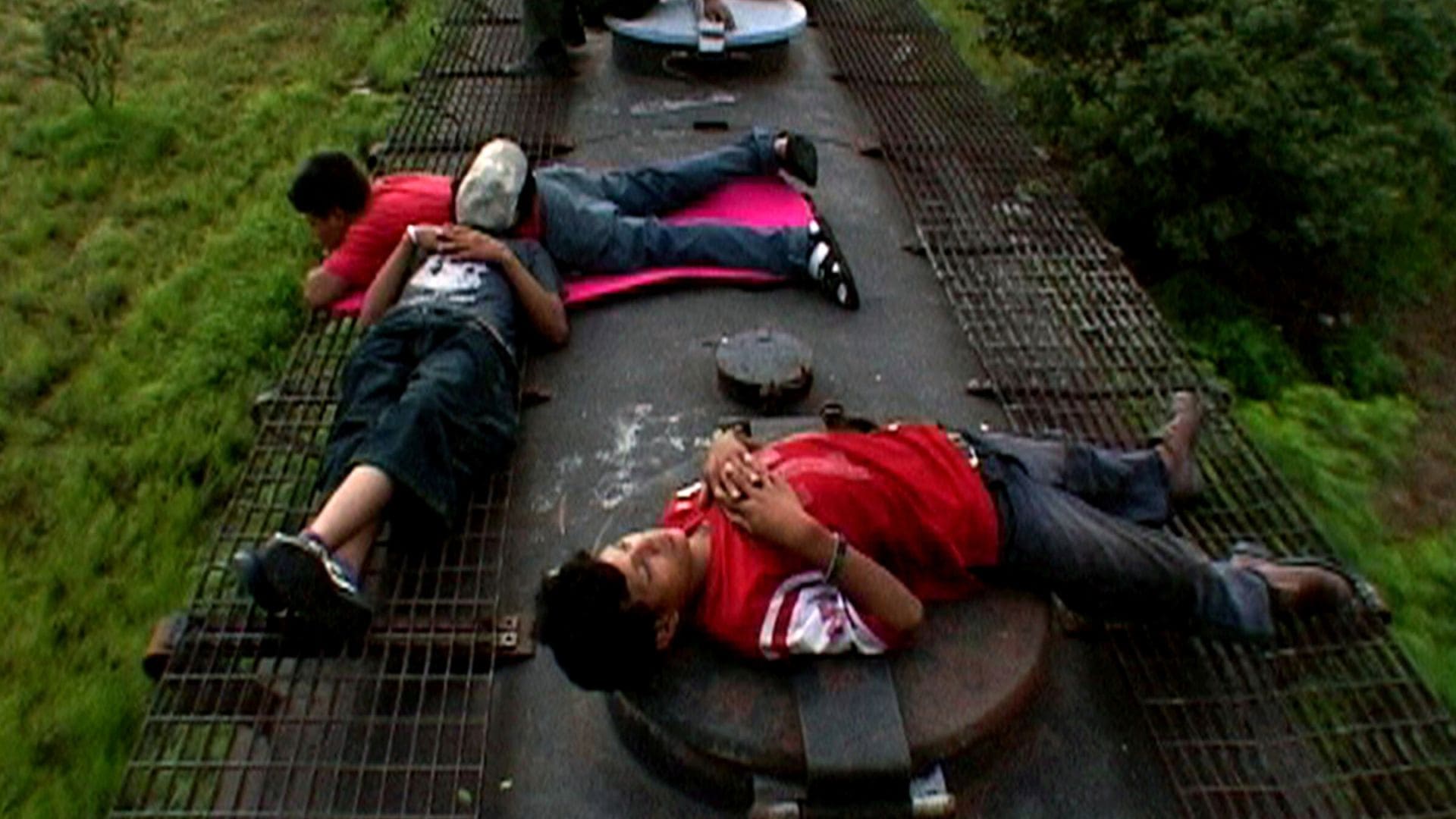 A group of boys lay sprawled across the ground.