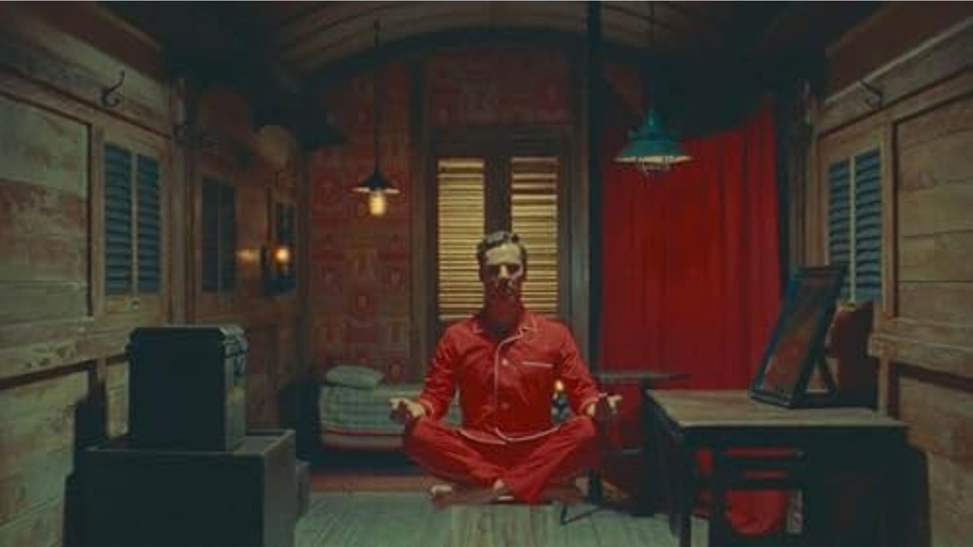 A man meditates in a bunker, floating a few feet above the ground.