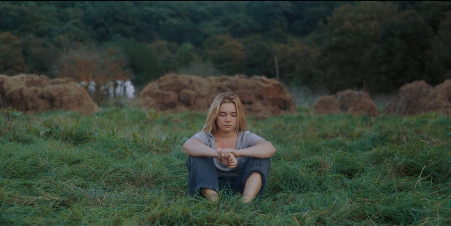 Scene in Midsommar where Dani is sitting alone in a field 